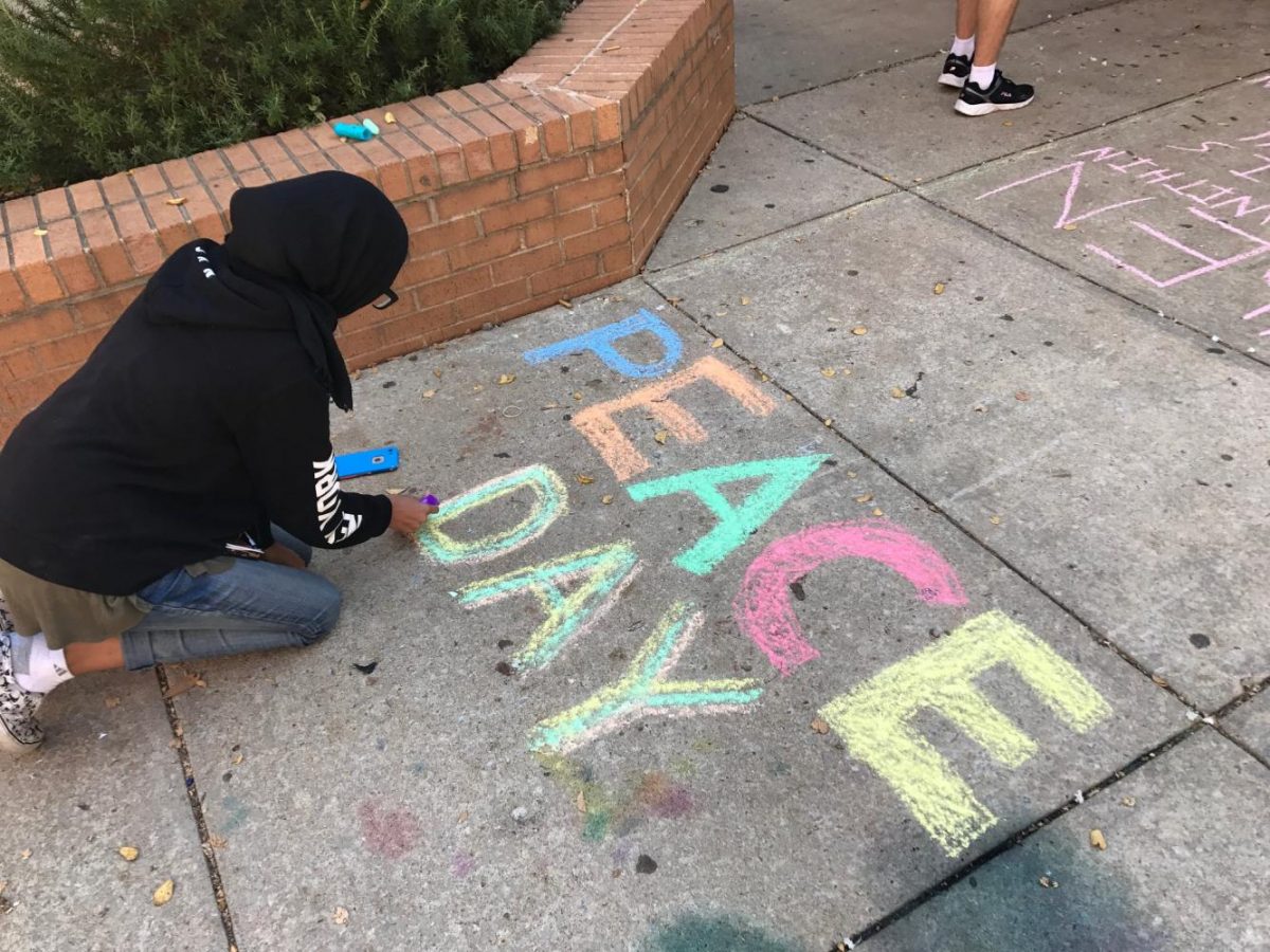 Global Issues and Global Politics students create chalk drawings and paintings to celebrate International Peace Day.