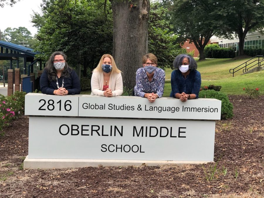 Dr. Diann Kearney standing behind the new Oberlin Middle School sign with Oberlins Assistant Principals.