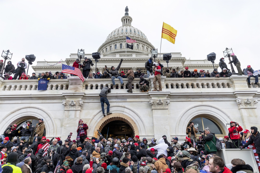 Rioters swarm the steps and balcony of the US Capitol building on January 6, 2021. 