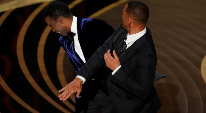 Will Smith hitting Chris Rock at the 2022 Oscars. Photo courtesy of Chris Pizzell/Invision/AP